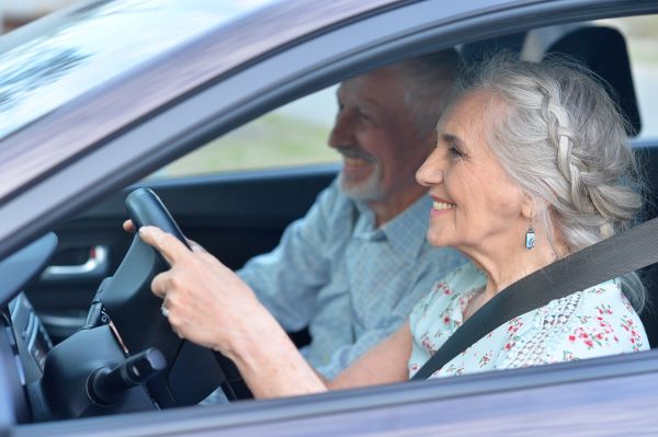 Elder couple driving behind the wheel